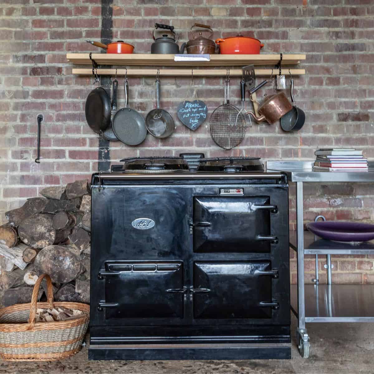 Traditional black cast iron stove in a rustic Norfolk barn setting.