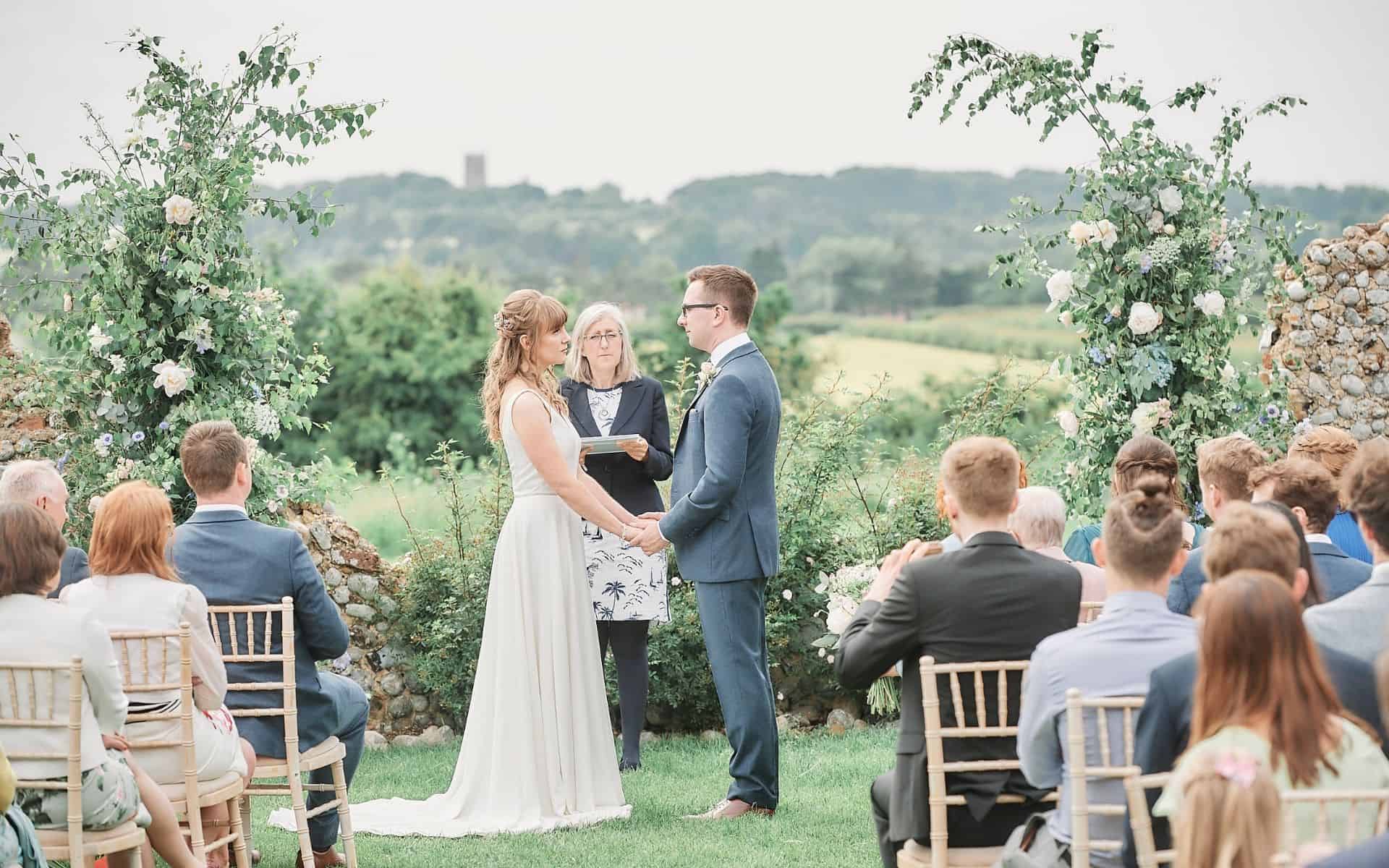Small wedding ceremony at Barn Drift Norfolk with outdoor scenic backdrop.